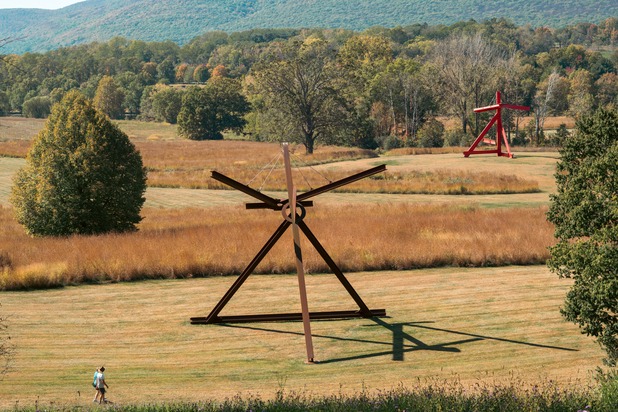 Large outdoor sculpture at Storm King Art Center with fields and hills in the background.